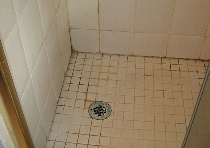 dirty shower tile and floor grout